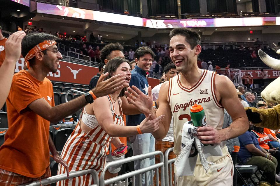 Texas forward Brock Cunningham celebrates a win over Oklahoma State at the Moody Center earlier this month with fans. Cunningham will tie the record for most UT games played at 144 if he suits up Saturday against Oklahoma, and he's only two wins short  of becoming the all-time winningest player in school history.