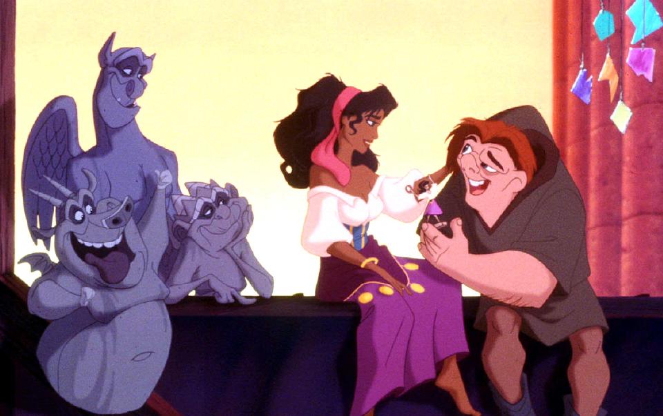 Quasimodo, the reclusive bell ringer of Notre Dame (R) meets Esmeralda, a Gypsy dancer as gargoyle plas-Victor, Hugo and Laverne look on in a scene from Walt Disney Pictures' new musical animated film "The Hunchback of Notre Dame." The film premieres in the United States June 19