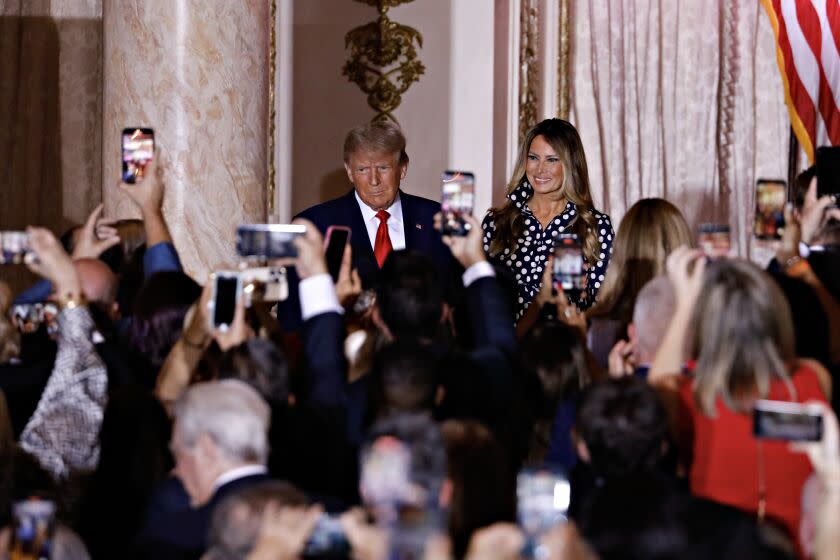 Former US President Donald Trump, center, arrives to speak with former First Lady Melania Trump, center right, at the Mar-a-Lago Club in Palm Beach, Florida, US, on Tuesday, Nov. 15, 2022. Trump formally entered the 2024 US presidential race, making official what he's been teasing for months just as many Republicans are preparing to move away from their longtime standard bearer. Photographer: Eva Marie Uzcategui/Bloomberg via Getty Images