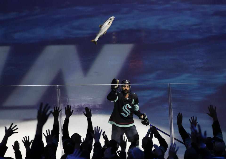 Seattle Kraken right wing Jordan Eberle throws a stuffed fish to fans after scoring to win the game against the Colorado Avalanche after Game 4 of an NHL hockey Stanley Cup first-round playoff series Monday, April 24, 2023, in Seattle. The Kraken won 3-2 in overtime. (AP Photo/Lindsey Wasson)