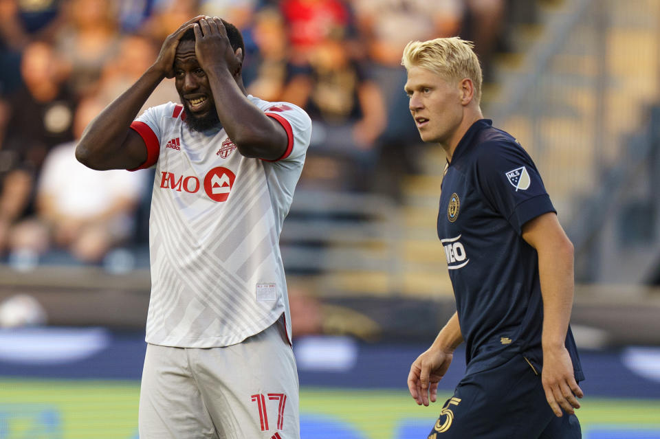 Toronto FC forward Jozy Altidore, left, reacts as Philadelphia Union defender Jakob Glesnes, right, looks on during the first half of an MLS soccer match, Wednesday, Aug. 4, 2021, in Chester, Pa. (AP Photo/Christopher Szagola)