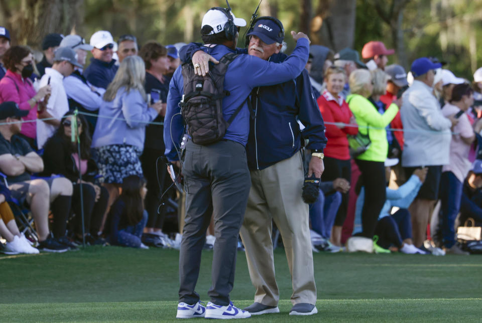 Golf analyst Roger Maltbie gets a hug from fellow analyst Notah Begay III (left) following the 2022 PNC Championship golf tournament at Ritz Carlton Golf Club Grande Lakes Orlando Course. (Reinhold Matay-USA TODAY Sports)