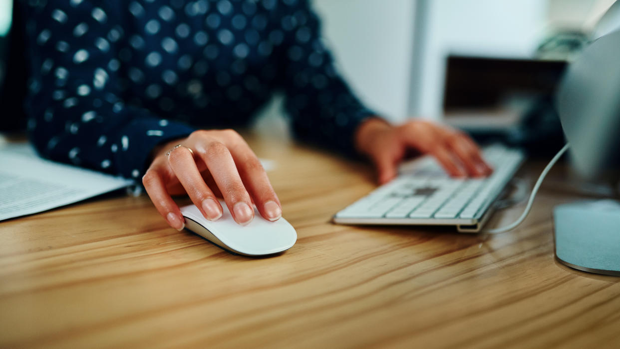 Closeup shot of an unrecognizable businesswoman working on a computer in an office at night.