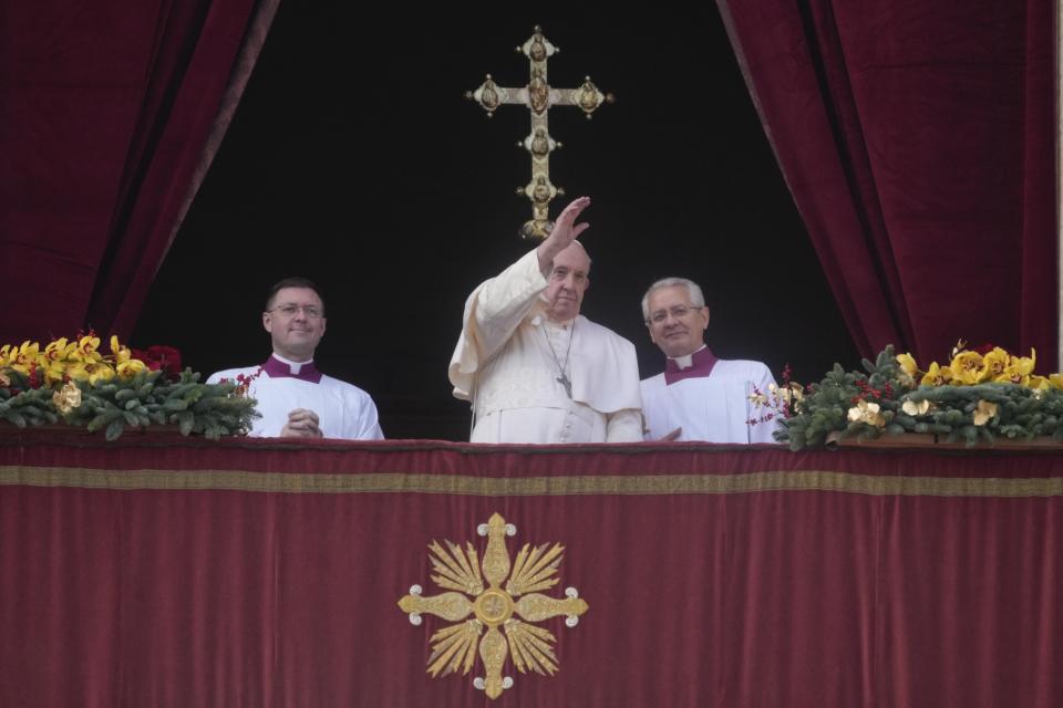 Pope Francis waves to faithful at the end of the Urbi et Orbi (Latin for 'to the city and to the world' ) Christmas' day blessing from the main balcony of St. Peter's Basilica at the Vatican, Sunday, Dec. 25, 2022. (AP Photo/Gregorio Borgia)