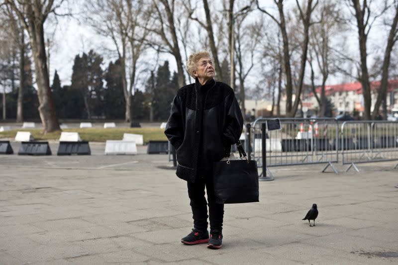 Jona Laks, survivor of Dr. Josef Mengele's twins experiments stands near the entrance to the Auschwitz death camp as she arrives for a visit with her granddaughter, in Oswiecim