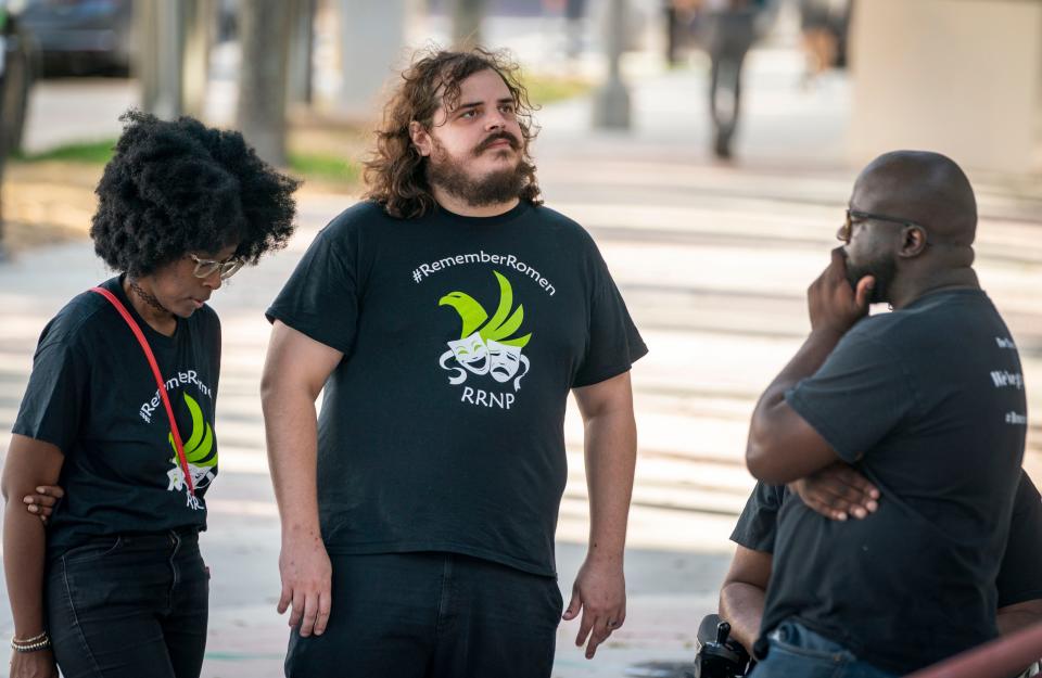 Abeni Matthews, left, Skylar Meany and Jermaine Williams remember their friend Romen Phelps after a press conference outside the West Palm Beach Police Department on May 13, 2023.