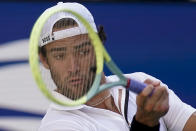 Matteo Berrettini, of Italy, returns a shot to Andy Murray, of Great Britain, during the third round of the U.S. Open tennis championships, Friday, Sept. 2, 2022, in New York. (AP Photo/Seth Wenig)