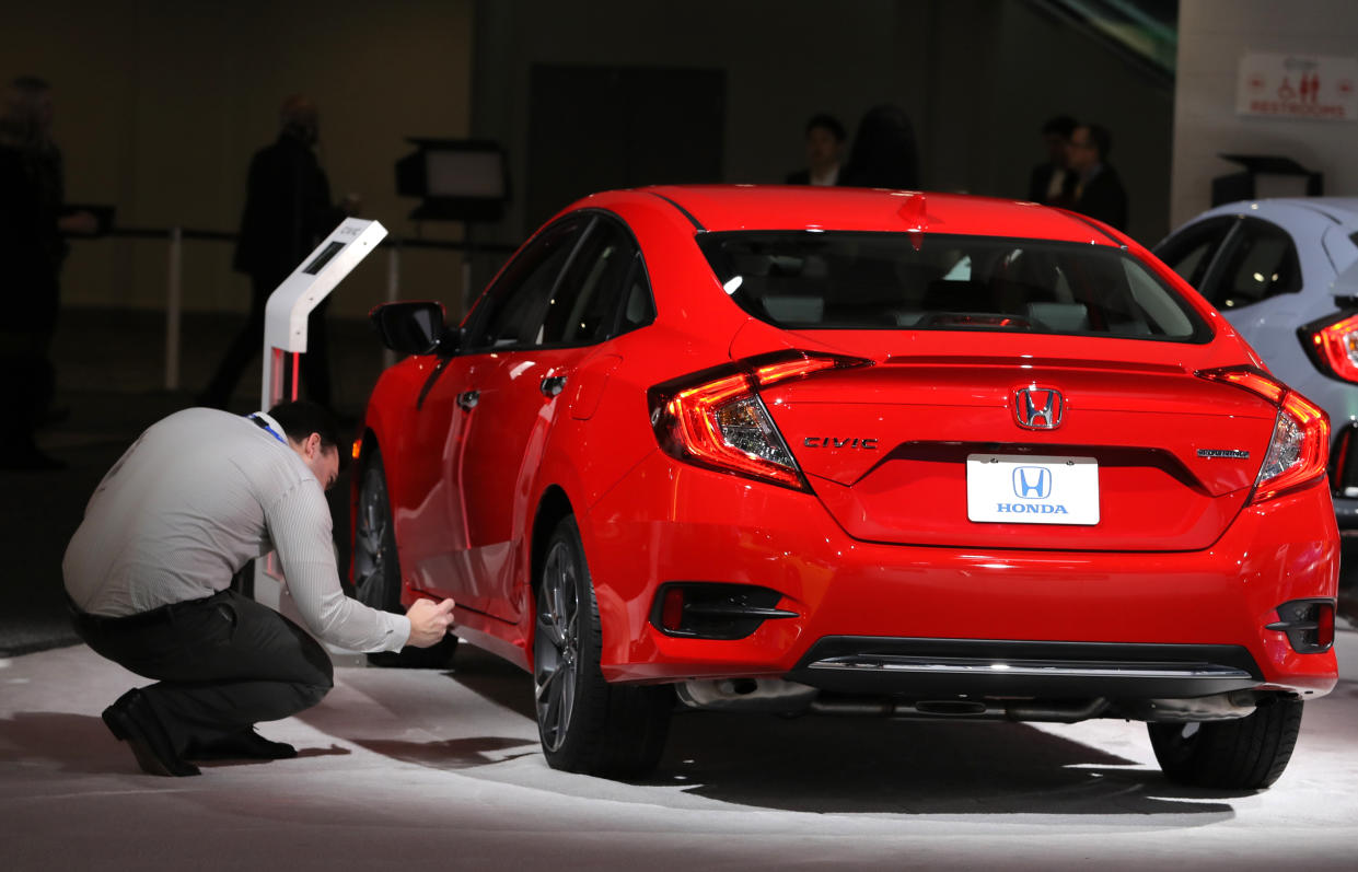 A member of the media takes a photograph of a detail on a Honda Civic at the North American International Auto Show in Detroit, Michigan, U.S., January 15, 2019. REUTERS/Brendan McDermid