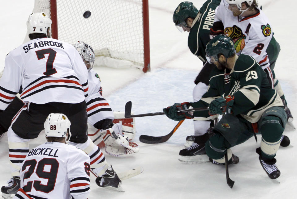 Minnesota Wild right wing Jason Pominville (29) scores on Chicago Blackhawks goalie Corey Crawford in front of Blackhawks defenseman Brent Seabrook (7) during the second period of Game 4 of an NHL hockey second-round playoff series in St. Paul, Minn., Friday, May 9, 2014. (AP Photo/Ann Heisenfelt)