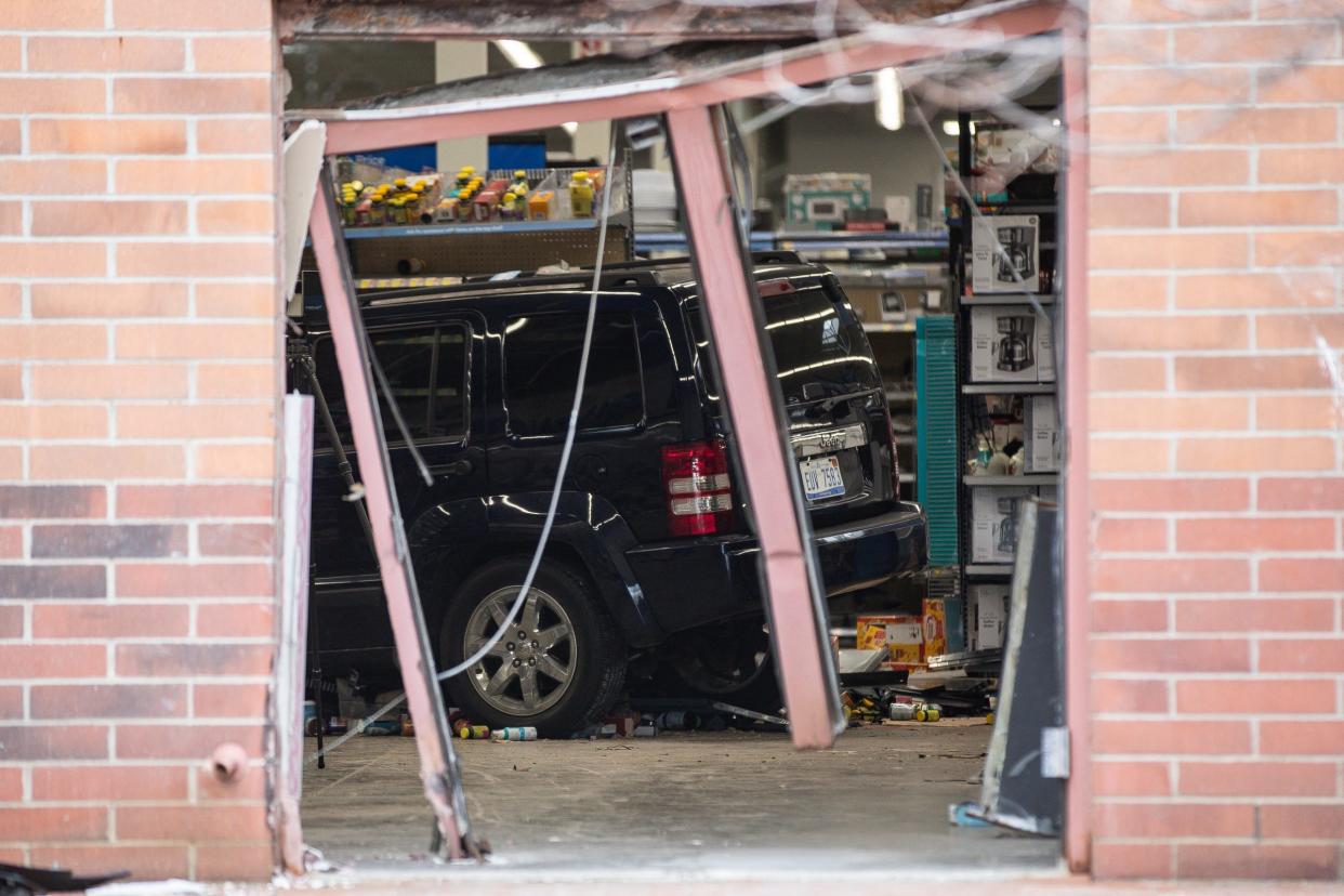 Police investigate the scene where a driver crashed an SUV into Walmart on Ford Road in Canton on Friday, March 1, 2024.