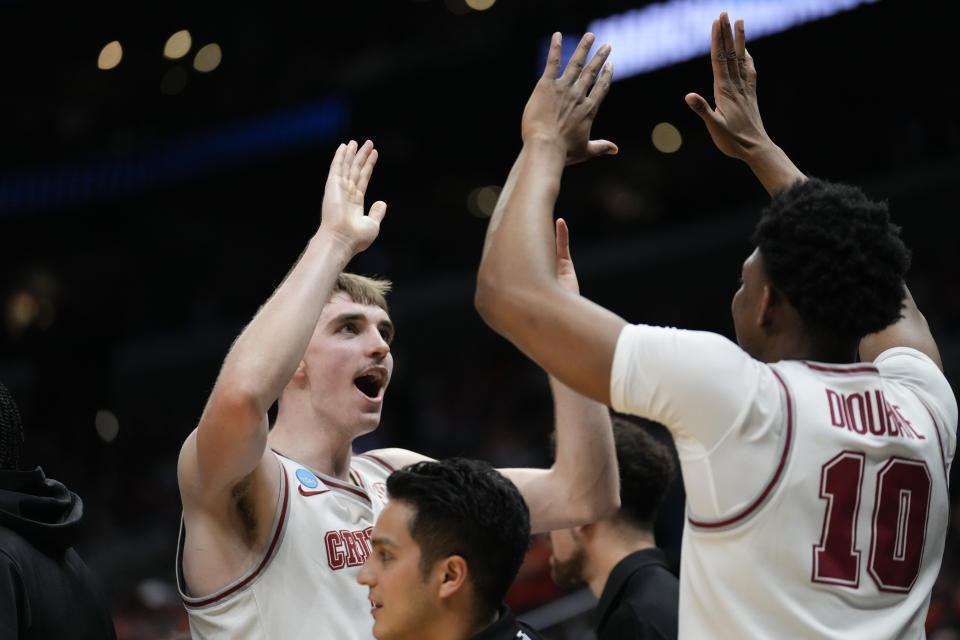 Alabama forward Grant Nelson celebrates with teammates on the bench during the first half of an Elite 8 college basketball game against Clemson in the NCAA tournament Saturday, March 30, 2024, in Los Angeles. (AP Photo/Ashley Landis)