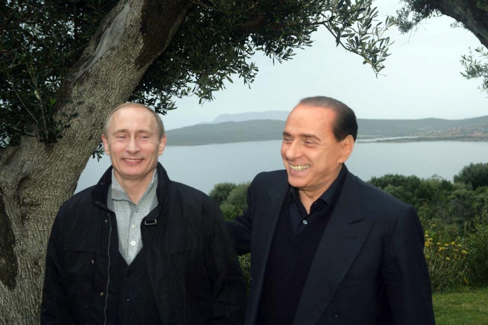 Putin (L) and the late Italian prime minister Berlusconi at the latter private summer residence villa 'La Certosa' (AFP via Getty Images)