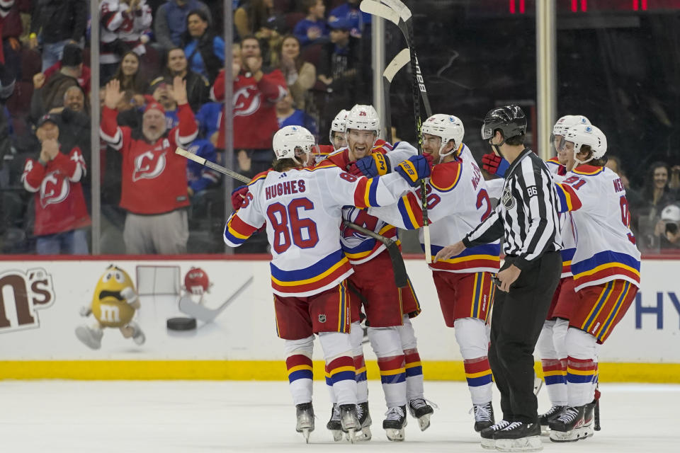 New Jersey Devils defenseman Damon Severson (28) celebrates with teammates after scoring the game-winning goal in overtime of an NHL hockey game against the New York Rangers, Saturday, Jan. 7, 2023, in Newark, N.J. The Devils won 4-3 in overtime. (AP Photo/Mary Altaffer)