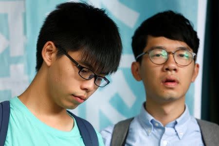 Student leaders Joshua Wong (L) and Nathan Law stand outside a court before a verdict, on charges of inciting and participating in an illegal assembly in 2014 which led to the "Occupy Central" pro-democracy movement, in Hong Kong August 15, 2016. REUTERS/Bobby Yip