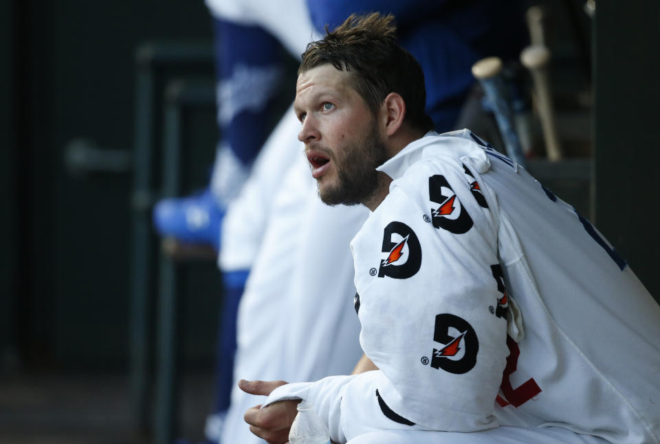 His arm wrapped in towels, Los Angeles Dodgers' Clayton Kershaw, pitching for the Oklahoma City Dodgers on a rehab assignment, watches from the dugout in the second inning against the San Antonio Missions in a Triple-A baseball game Thursday, April 4, 2019, in Oklahoma City. (AP Photo/Sue Ogrocki)