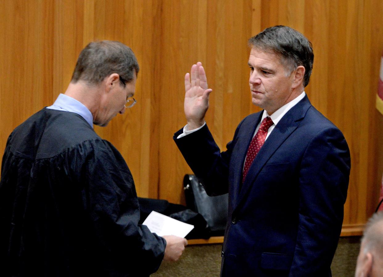 Seventh Circuit Judge John M. "Mo" Madonia, left, swears in John C. Milhiser as Sangamon County state's attorney at the county board meeting Tuesday, Nov. 14, 2023. Milhiser, who succeeds Daniel K. Wright, previously served as state's attorney from 2010 to 2018.