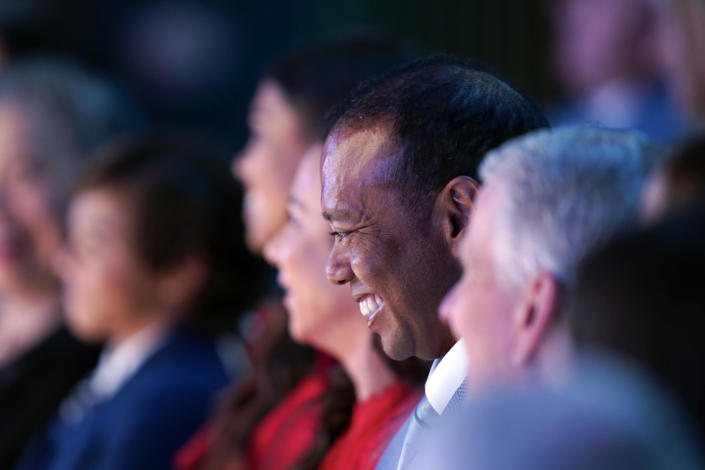 Tiger Woods laughs as Susie Maxwell Berning speaks during his induction into the World Golf Hall of Fame Wednesday, March 9, 2022, in Ponte Vedra Beach, Fla. (AP Photo/Gerald Herbert)