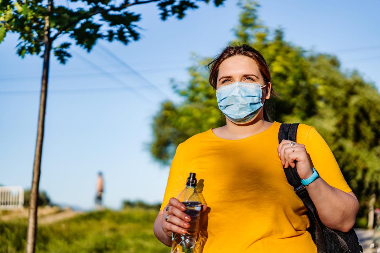 masked woman walk