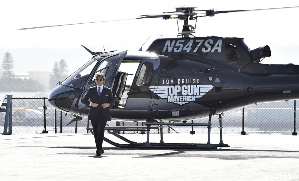 Tom Cruise walks to the red carpet after riding a helicopter to the world premiere of "Top Gun: Maverick" on Wednesday, May 4, 2022, at the USS Midway in San Diego. (Photo by Jordan Strauss/Invision/AP)