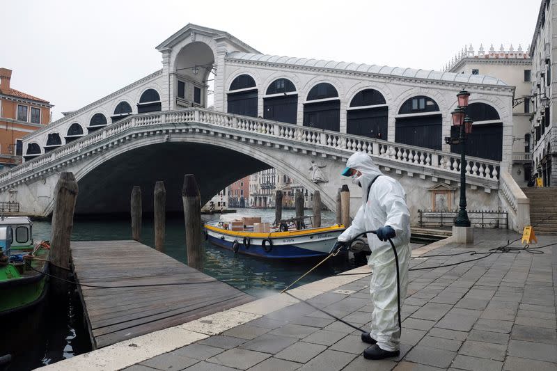 A worker sanitises the Rialto Bridge as a measure against the coronavirus disease (COVID-19) in Venice