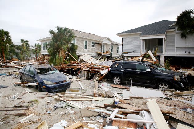 Remnants of damaged homes and flooded vehicles are seen in Fort Myers Beach on Sept. 29, 2022. (Photo: Douglas R. Clifford/Tampa Bay Times via AP)