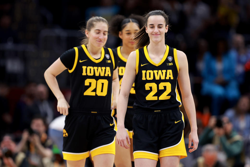 Iowa's Caitlin Clark and Kate Martin watch the Hawkeyes' national championship game against South Carolina on Sunday.  (Gregory Shams/Getty Images)