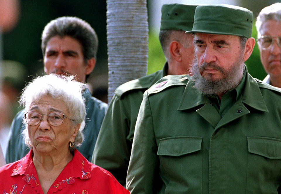 FILE - In this May 8, 1999 file photo, Cuba's leader Fidel Castro, right, stands with Melba Hernandez, the wife of Jesus Montane, during Montane's burial at Colon Cemetery in Havana, Cuba. Hernandez, who helped Castro launch his revolutionary battle with a failed 1953 attack on a military barracks and was later named a "heroine of the Cuban Revolution," has died. She was 92. (AP Photo/Jose Goitia, File)
