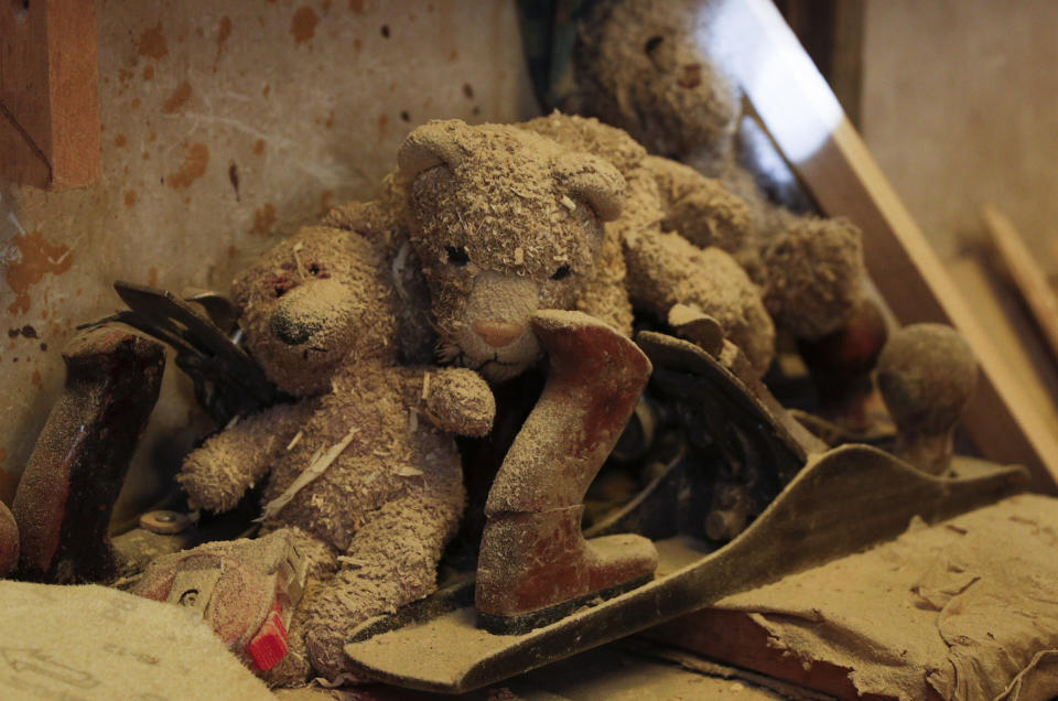 Teddy Bears covered in sawdust sit nex to tools at a family-run carpentry workshop in El Alto, Bolivia, Friday, Aug. 28, 2020. In Bolivia, the government decided to cancel the school year in August because it said there was no way to provide an equitable education to the country's nearly 3 million students. (AP Photo/Juan Karita)