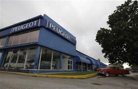 A 1952 Ford car is parked inside the Peugeot agency in Havana January 3, 2014. REUTERS/Enrique de la Osa