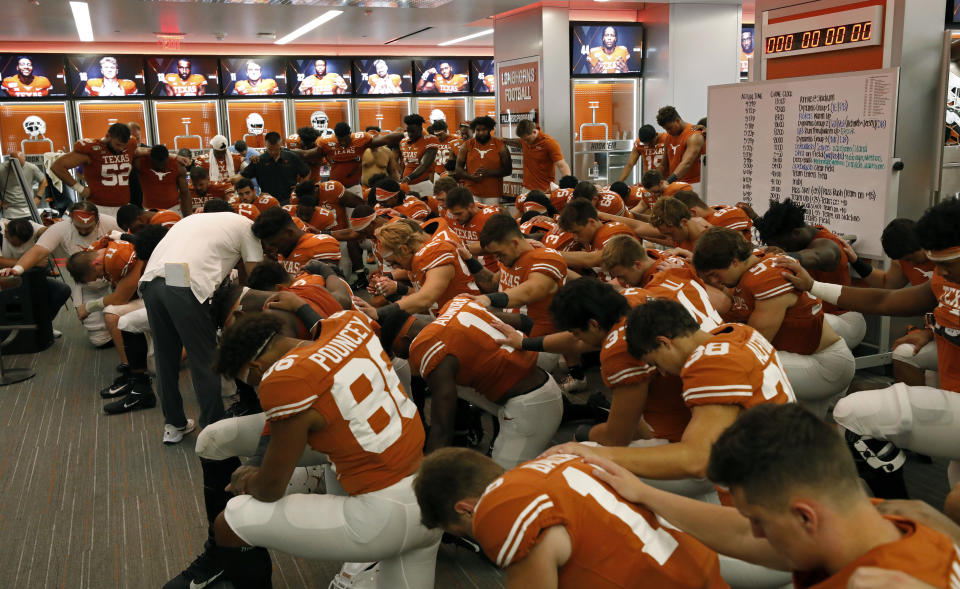 The Texas Longhorns football team prays in the locker room after the game against the LSU Tigers Saturday Sept. 7, 2019 at Darrell K Royal-Texas Memorial Stadium in Austin, Tx. LSU won 45-38. ( Photo by Edward A. Ornelas )