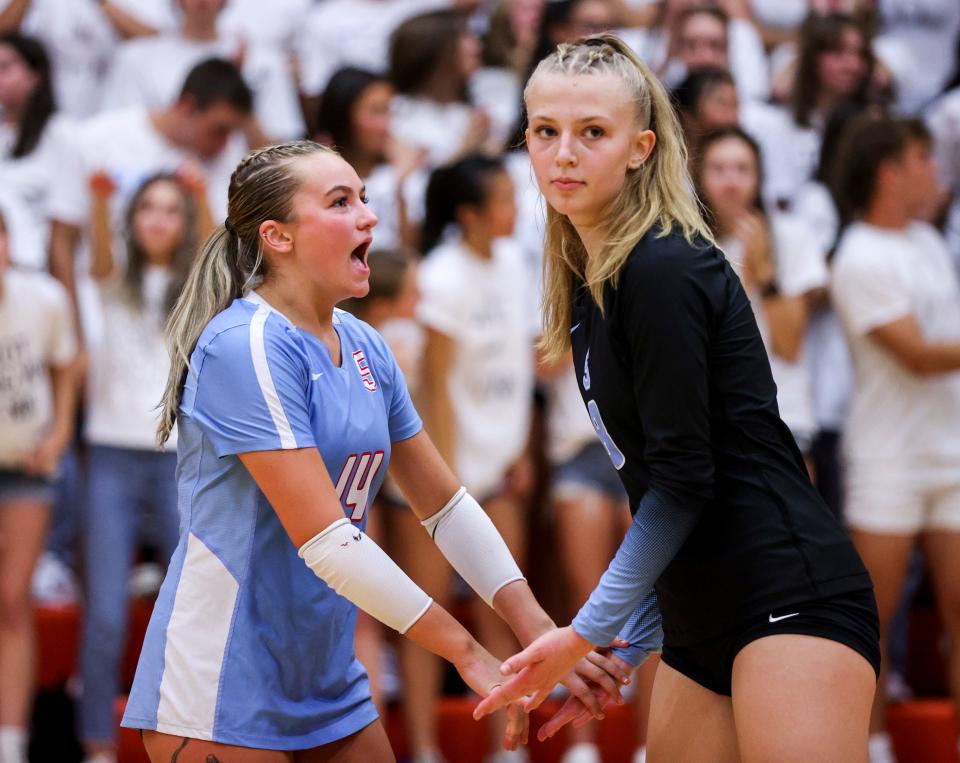 South Salem’s Avery Axmaker (14) high fives Briella Mathis (8) between plays in the match against Sprague on Sept. 14 in Salem.