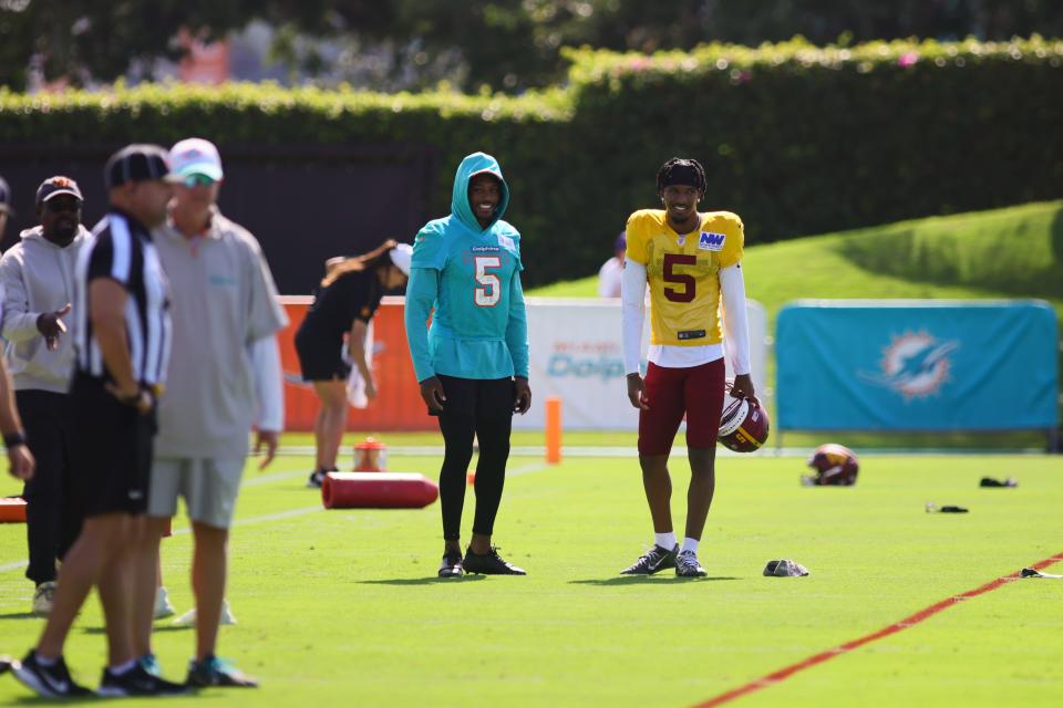 Aug 15, 2024; Miami Gardens, FL, USA; Miami Dolphins cornerback Jalen Ramsey (5) and Washington Commanders quarterback Jayden Daniels (5) talk on the field during joint practice at Baptist Health Training Complex. Mandatory Credit: Sam Navarro-USA TODAY Sports