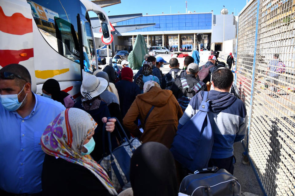 In this Friday, May 22, 2020, photo, Moroccan citizens wait for repatriation after being stranded in Spain due to the coronavirus pandemic in the Spanish enclave of Ceuta, Spain. (Faro de Ceuta via AP)