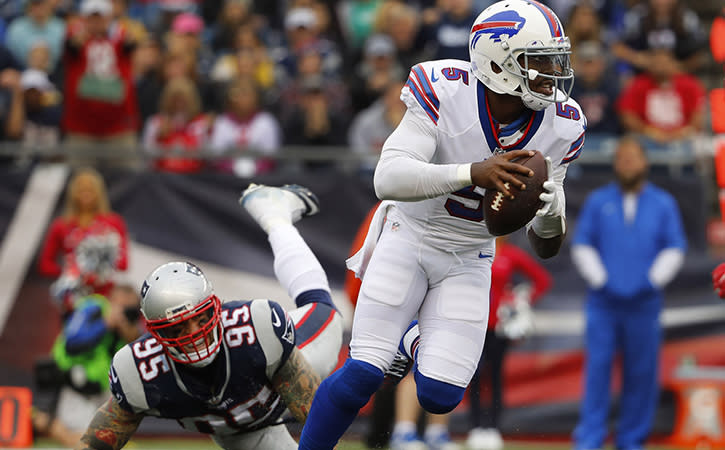 Oct 2, 2016; Foxborough, MA, USA; Buffalo Bills quarterback Tyrod Taylor (5) scrambles away from New England Patriots defensive end Chris Long (95) during the second half of the Buffalo Bills 16-0 win over the New England Patriots at Gillette Stadium.