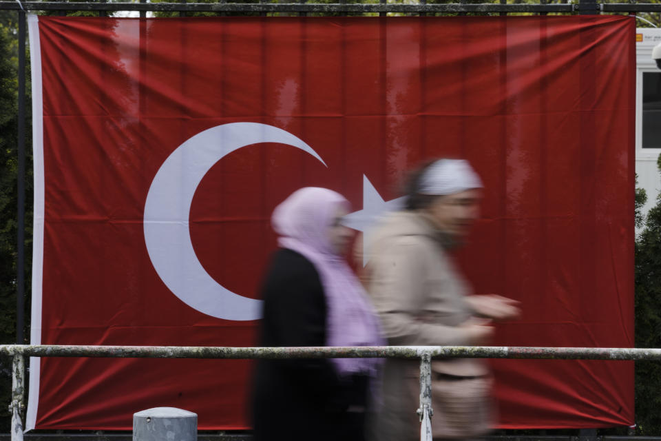 Turkish citizens living in Germany leave a polling station inside the Turkish consulate after they cast their vote for Turkish the parliament and president election in Berlin, Germany, Thursday, April 27, 2023. Millions of Turkish citizens living abroad have began voting in national elections that will decide whether President Recep Tayyip Erdogan can govern Turkey for another term. Among the biggest contingent of overseas voters are 1.5 million Turks in Germany, who can cast their votes in presidential and parliamentary elections at 16 polling sites across the country until May 9. (AP Photo/Markus Schreiber)