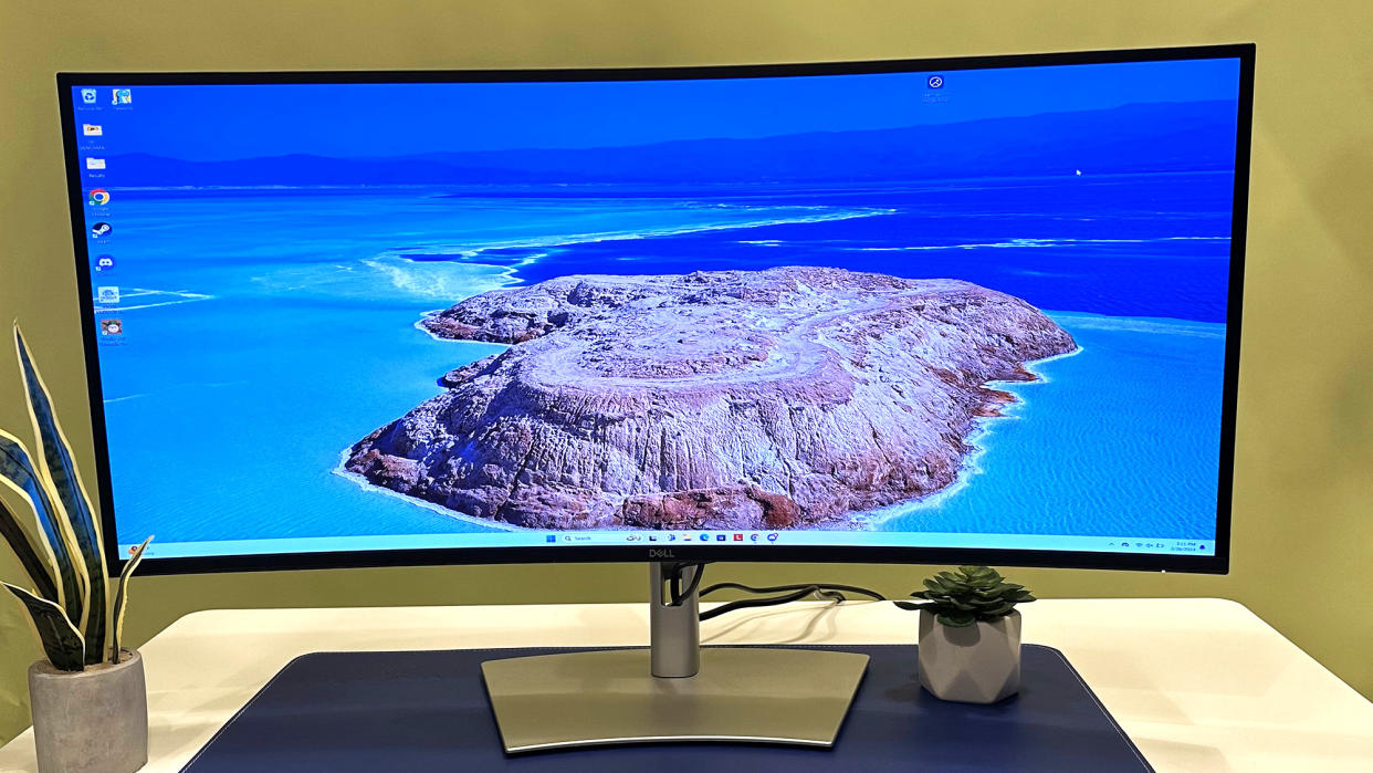  Dell UltraSharp 40 Thunderbolt Curved Hub Monitor on a desk with an island scene on the screen. 