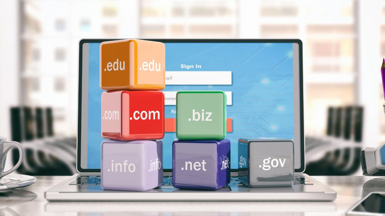  Domain names cubes on a laptop - office background 