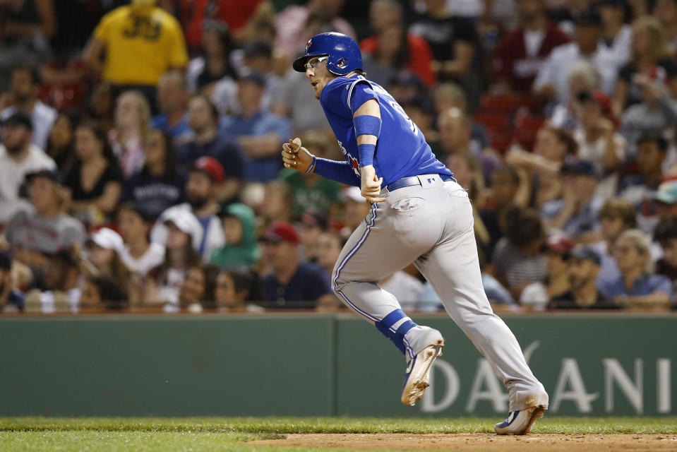 Jul 15, 2019; Boston, MA, USA; Toronto Blue Jays catcher Danny Jansen (9) hits an RBI single against the Boston Red Sox during the eighth inning at Fenway Park. Mandatory Credit: Greg M. Cooper-USA TODAY Sports