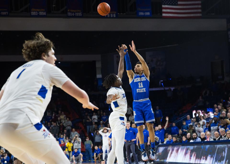 Jan 4, 2024; Tulsa, Oklahoma, USA; Memphis Tigers guard Jahvon Quinerly (11) hits a three point shot over Tulsa Golden Hurricane forward Carlous Williams (12) for the go ahead and eventual game winner against the Tulsa Golden Hurricane at Reynolds Center. The Memphis Tigers won the game 78-75.
