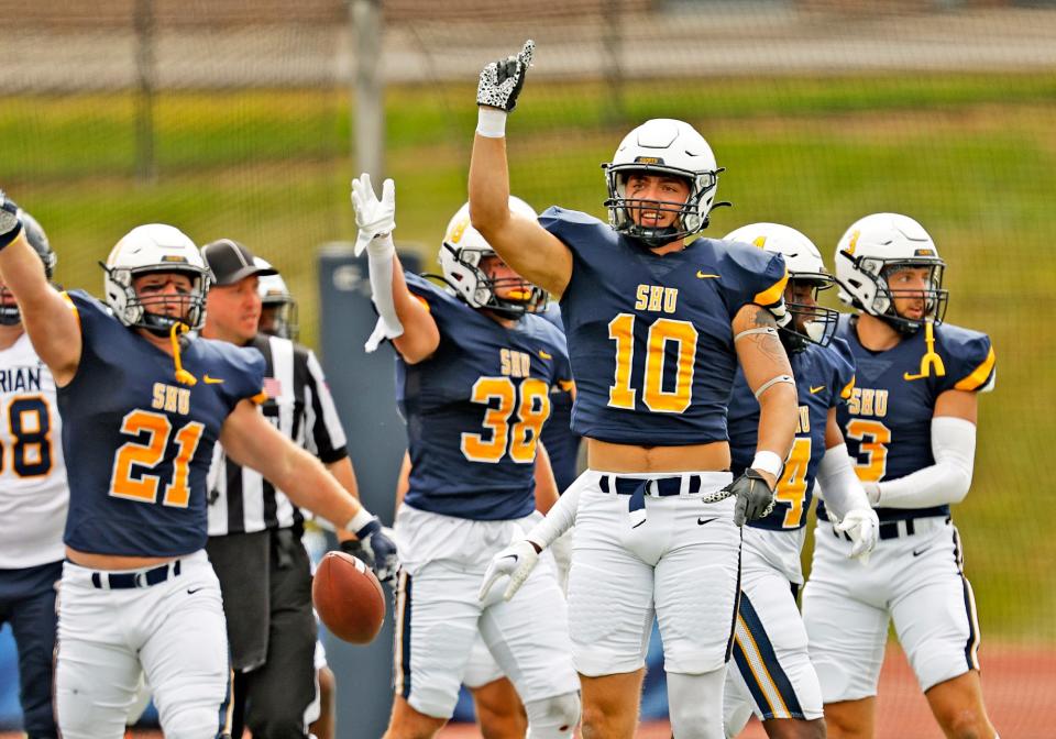 Siena Heights' Joshua Mack celebrates a stop during a game against Marian (Ind.).