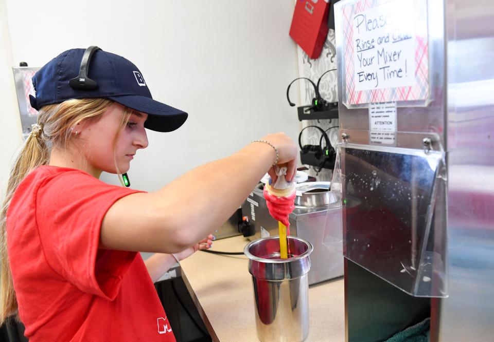 Mckenzie Vickery, 14, dips a cone at the B&G Milky Way on 69th Street on Thursday, April 7, 2022, in Sioux Falls.