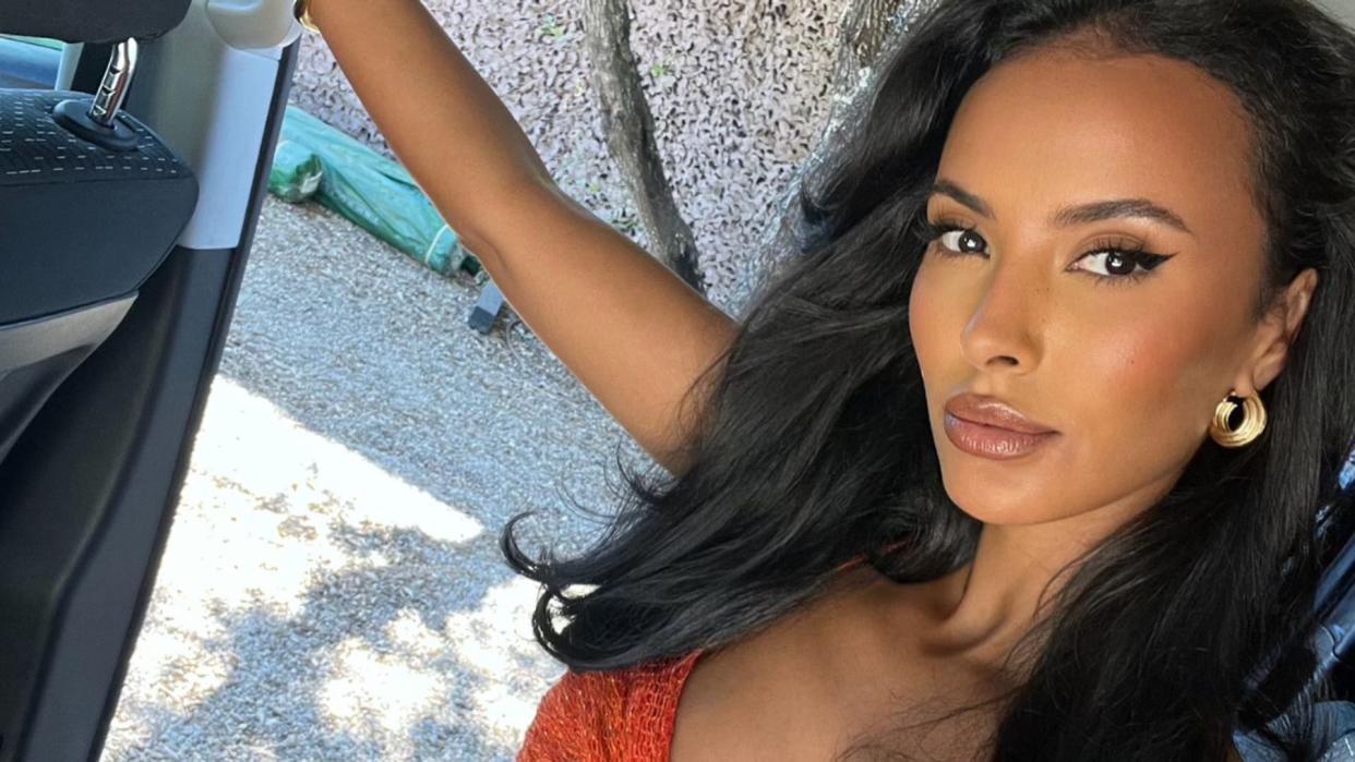 Maya Jama poses in an orange dress on her instagram 