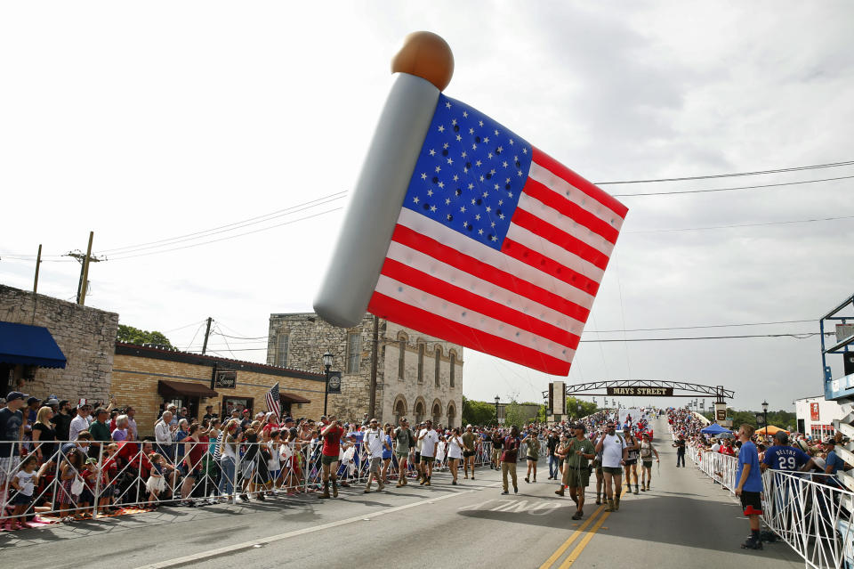 A helium inflatable American flag makes its way along Mays Street in the Fourth of July parade in Round Rock, Texas, on Wednesday, July 4, 2018. (Jay Janner/Austin American-Statesman via AP)