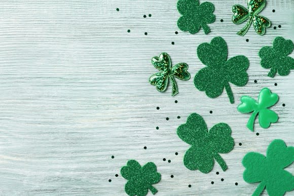 Green shamrocks on a wooden board.