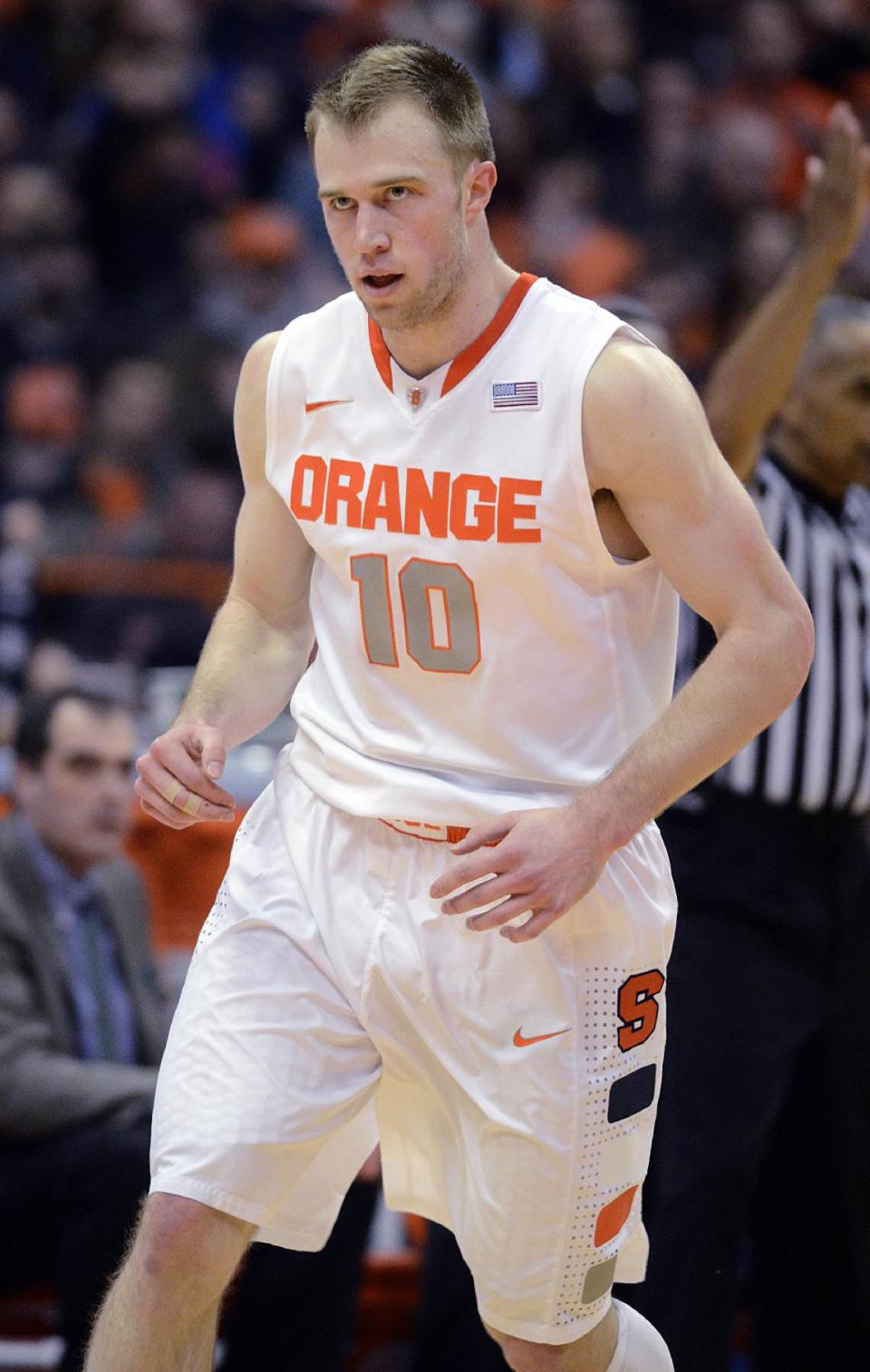 Syracuse's Trevor Cooney runs back on defense after hitting a three-point shot against Notre Dame during the first half of an NCAA college basketball game in Syracuse, N.Y., Monday, Feb. 3, 2014. (AP Photo/Kevin Rivoli)