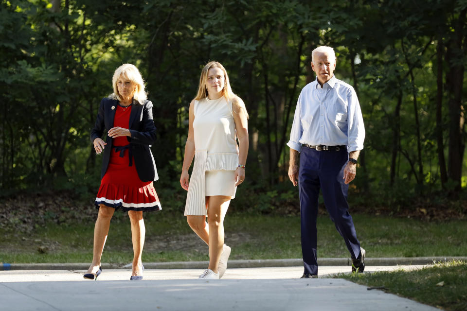 Former Vice President and Democratic presidential candidate Joe Biden, his wife Jill, left, and their granddaughter Finnegan, center, arrive at a house party at former Agriculture Secretary Tom Vilsack's house, Monday, July 15, 2019, in Waukee, Iowa. (AP Photo/Charlie Neibergall)