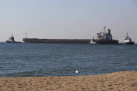 The Glory bulk carrier, center, makes its way from the port in Odesa, Ukraine, Sunday, Aug. 7, 2022. According to Ukraine's Ministry of Infrastructure, the ship under the Marshall Islands' flag is carrying 66 thousand tons of Ukrainian corn. (AP Photo/Nina Lyashonok)