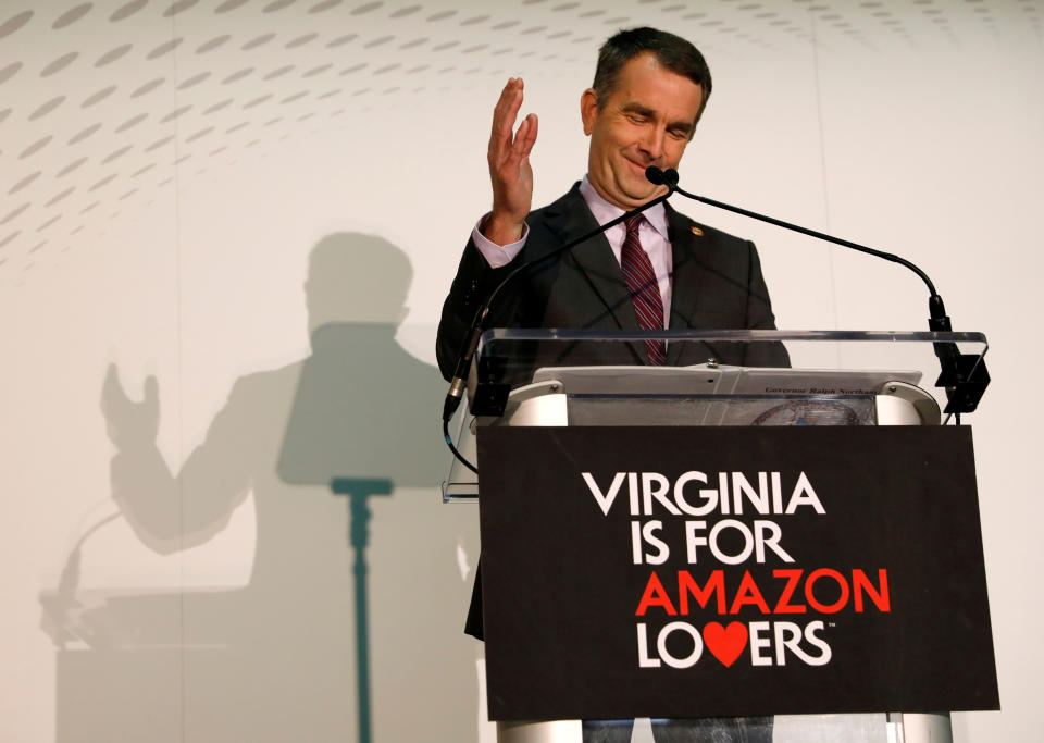 Behind a “Virginia is for Amazon Lovers” sign, Virginia Governor Ralph Northam speaks at a news conference after the announcement that Crystal City has been selected as home to Amazon’s new headquarters in Arlington, Virginia, U.S., November 13, 2018. REUTERS/Kevin Lamarque