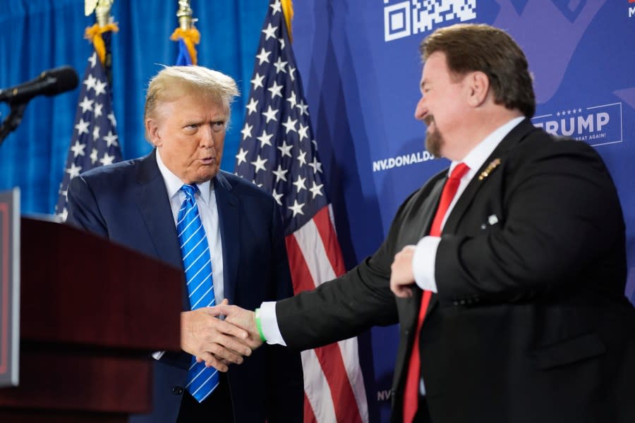 FILE – Nevada GOP chair Michael McDonald, right, shakes hands with Republican presidential candidate former President Donald Trump at a campaign event, Jan. 27, 2024, in Las Vegas. A Nevada state court judge dismissed a criminal indictment Friday, June 21, 2024, against six Republicans accused of submitting certificates to Congress falsely declaring Donald Trump the winner of the state’s 2020 presidential election. (AP Photo/John Locher, File)