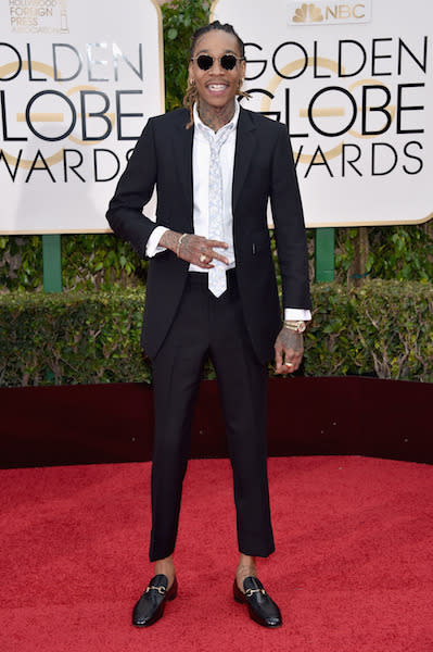 Wiz Khalifa in a black suit and Gucci loafers at the 73rd Golden Globe Awards.
